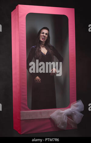 scary vampire woman in pink doll box Stock Photo