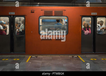 A Mexico City Metro train stopping at Miguel Ángel de Quevedo station Stock Photo