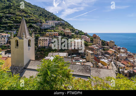 View of the seaside village of Riomaggiore and the Church of San Giovanni Battista, Cinque Terre, Liguria, Italy Stock Photo