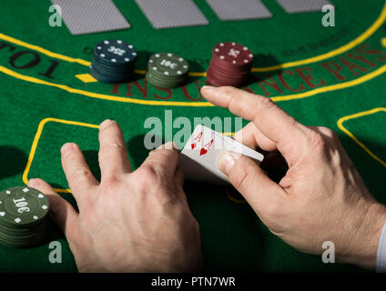 Winning combination in poker game. Cards and chips on a green cloth Stock Photo