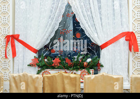 Window with white curtains decorated for Christmas. In room. Stock Photo