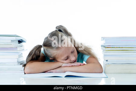 Exhausted sweet cute blonde girl sleeping on a pile of schoolbooks after being studying hard isolated on a withe background in too much learning press Stock Photo