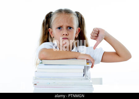 Angry little girl with a negative attitude towards studies and school after studying too much and having too many homework in children education conce Stock Photo