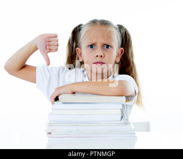 Angry little girl with a negative attitude towards studies and school after studying too much and having too many homework in children education conce Stock Photo