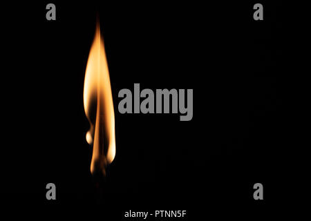 Match with strongly flaring flame on a black background closeup Stock Photo