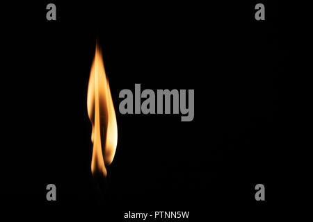 Match with strongly flaring flame on a black background closeup Stock Photo