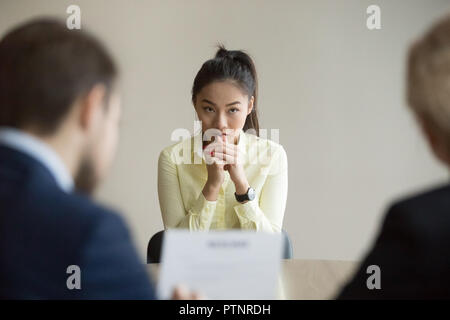 Nervous Asian applicant stressed at job interview Stock Photo