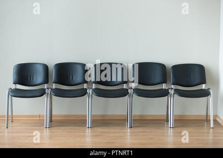 Row of black office chairs in conference room Stock Photo