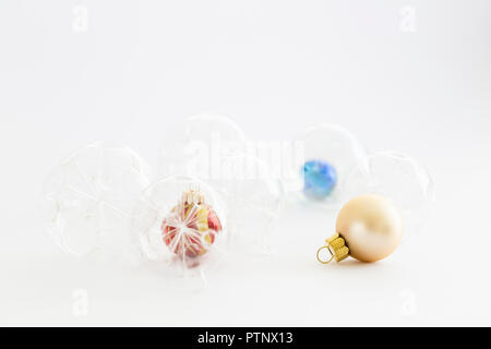 Still life with beautiful decorative transparent, red and blue christmas glass balls on white background Stock Photo