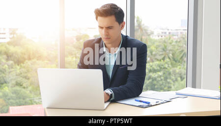 businessmen using notebook and fill serious about the work done until the headache Stock Photo