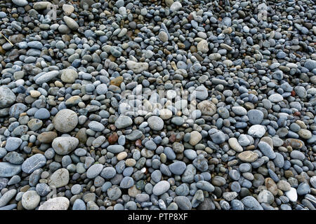 Pebbles of different colours and sizes on a stoney beach Stock Photo