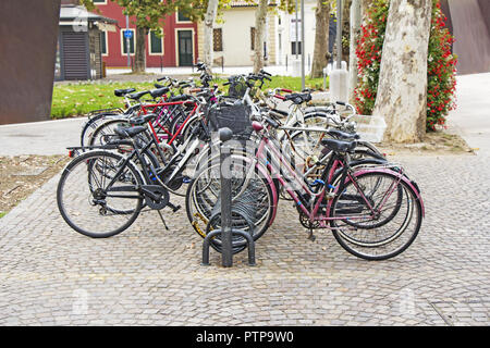 Bicycles parked on street in city Stock Photo