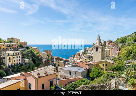 View of the seaside village of Riomaggiore and the Church of San Giovanni Battista, Cinque Terre, Liguria, Italy Stock Photo