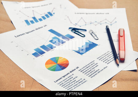 Financial dummy statistics document report with pie graph, bar chart, line graph on the table with pencil and highlight pen. Financial revenue, Market Stock Photo