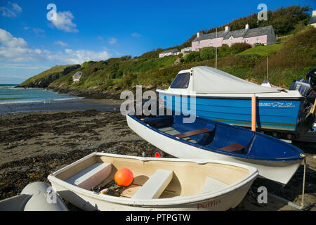 Small boats hauled up on the beach at Abercastle, Pembrokeshire, West Wales. Stock Photo