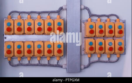 Many buttons located on the wall in a modern factory, close-up, control panel, production Stock Photo