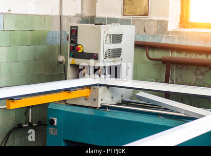 Production of pvc windows, gluing of plastic corners of windows, machine for the production of pvc windows, profile Stock Photo