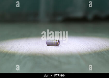 Sleeve from the gun lies on the floor of the house, close-up Stock Photo