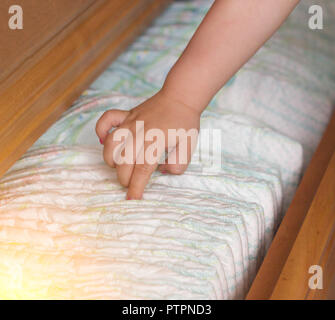 child's hand takes out diapers, close-up Stock Photo