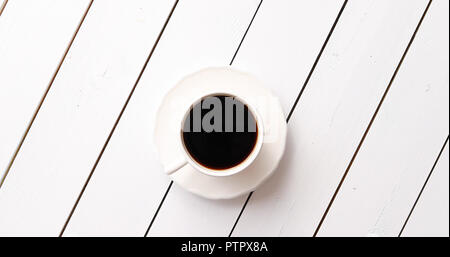 Cup of hot beverage on table Stock Photo