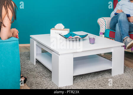 Meeting between woman patient and professional psychologist in his office. Psychologist taking notes in psychotherapy session. Stock Photo