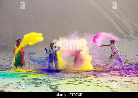 Rajasthani man and woman playing holi with colours.