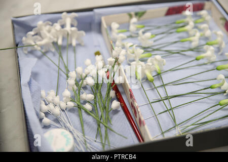 Floral cake decorations used by Sophie Cabot as she prepares and bake parts of Princess Eugenie's red velvet and chocolate wedding cake at Buckingham Palace in London. Stock Photo