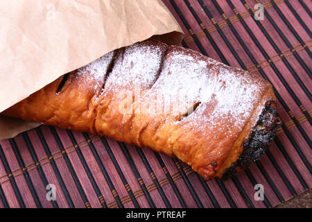 Poppy seed and walnut rolls, traditional Chistmas beigli cake on wooden table. Stock Photo