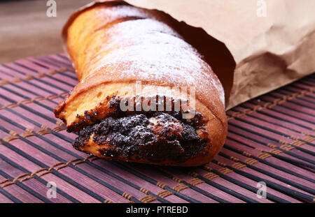 Poppy seed and walnut rolls, traditional Chistmas beigli cake on wooden table. Stock Photo