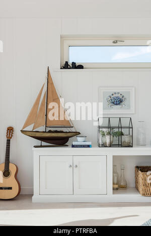 Wooden sailing boat with crab painting and guitar Stock Photo