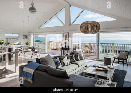 Open plan living room with view to sea Stock Photo