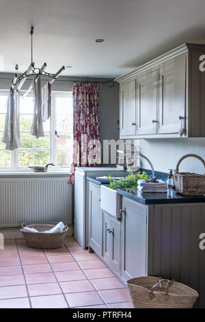 Laundry airer and butler sink in utility room of restored 16th century farmhouse Stock Photo