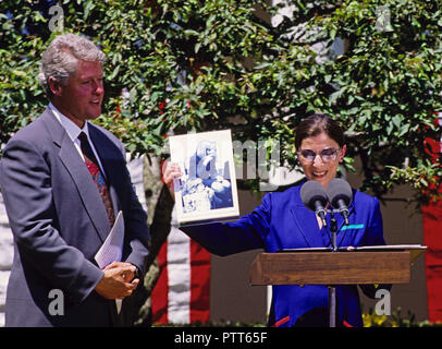 Washington, District of Columbia, USA. 14th June, 1993. Judge Ruth Bader Ginsburg of the United States Court of Appeals for the District of Columbia holds a photo of her granddaughter Clara with first lady Hillary Rodham Clinton that was taken in October 1992 during the ceremony where she was nominated to the United States Supreme Court by US President Bill Clinton in the Rose Garden of the White House in Washington, DC on June 14, 1993. If confirmed, Judge Ginsburg will replace Associate Justice Byron R. White Credit: Ron Sachs/CNP/ZUMA Wire/Alamy Live News Stock Photo