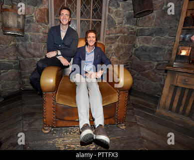 Potsdam, Brandenburg. 11th Oct, 2018. The actors James (r) and Oliver Phelps who sit in the Harry Potter films The Weasley Twins at the press conference for the 'Harry Potter' exhibition in the set of Hagrid's hut. The exhibition, which opens for visitors on Saturday (13.04.2018) in the Filmpark Babelsberg, shows costumes and complete sets of the film series. Credit: Bernd Settnik/dpa-Zentralbild/dpa/Alamy Live News Stock Photo
