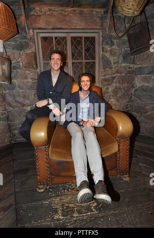 Potsdam, Brandenburg. 11th Oct, 2018. The actors James (r) and Oliver Phelps who sit in the Harry Potter films The Weasley Twins at the press conference for the 'Harry Potter' exhibition in the set of Hagrid's hut. The exhibition, which opens for visitors on Saturday (13.10.2018) in the Filmpark Babelsberg, shows costumes and complete sets of the film series. Credit: Bernd Settnik/dpa-Zentralbild/dpa/Alamy Live News Stock Photo