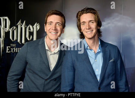 Potsdam, Brandenburg. 11th Oct, 2018. The actors James (r) and Oliver Phelps, who play the Weasley twins in the Harry Potter films, are guests at the press conference for the 'Harry Potter' exhibition. The exhibition, which opens for visitors on Saturday (13.10.2018) in the Filmpark Babelsberg, shows costumes and complete sets of the film series. Credit: Bernd Settnik/dpa-Zentralbild/dpa/Alamy Live News Stock Photo