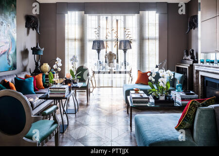 Daybeds designed by Stephen Ryan with lamps on table in window Stock Photo
