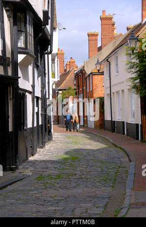 Two people walking along Middle Row, Faversham, Kent, England Stock Photo