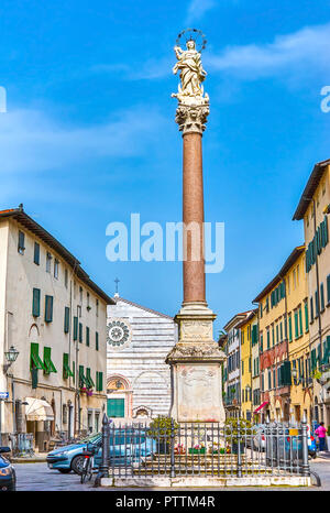 The medieval column with sculpture called Madonna of Stellario located in old town of Lucca, Italy Stock Photo