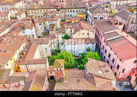 The old residential neighborhood in the heart of medieval town attracts tourists its authentic houses and courtyards, Lucca, Italy Stock Photo