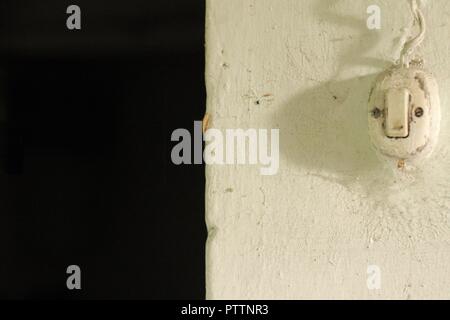 Vintage light switch in the wall (Marche, Italy, Europe) Stock Photo