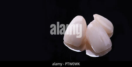 dental ceramic veneers and crowns isolated with mirror background. Stock Photo