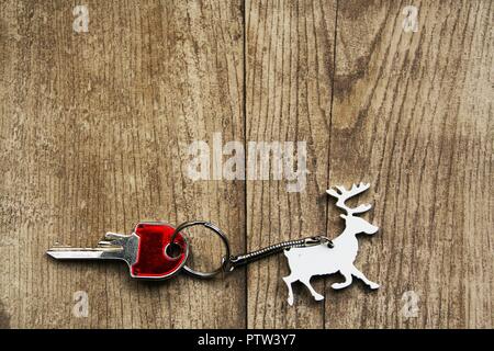 christmas keyring in shape of reindeer carrying a red  key Stock Photo
