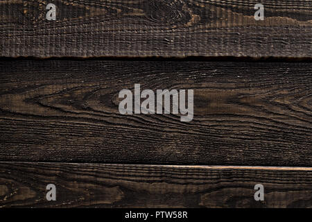 Close up of dark rustic wall made of old wood table planks texture. Rustic brown wood table texture background template for your design. Stock Photo