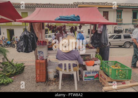 A MAN SITTING IN FRONT OF HIS MARKET STALL - JERICO - COLOMBIA Stock Photo