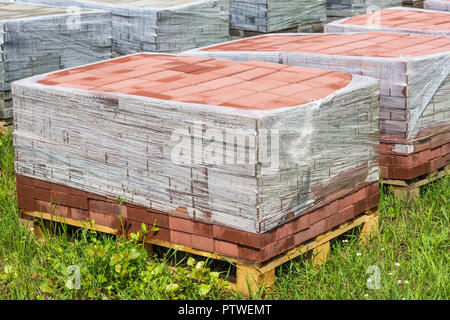 Red paving slab on pallets, red paving brick Stock Photo