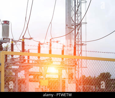 Power transformer in high voltage switchyard in modern electric substation, power and sun Stock Photo