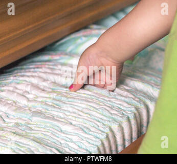 child's hand takes out diapers, close-up Stock Photo