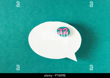 White bubble message from a paper on a turquoise background, social network, symbol Stock Photo