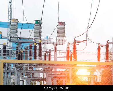 Power transformer in high voltage switchyard in modern electric substation, power station and sunset Stock Photo